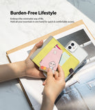 Card Holder | Flip [2 Pack] - Hands holding a yellow flip card holder attached to a clear phone case with cards inside.