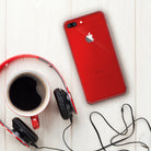 iPhone 8 Plus / 7 Plus Case | Fusion - Red iPhone in a clear case next to a coffee mug and red headphones on a white wood table.