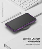 Galaxy S10e Case | Fusion-X - Purple Galaxy S10e in a Fusion-X case resting on a wireless charging pad near a white keyboard.