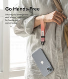 Hand Strap | Basic - A person wearing a pink-to-white gradient wrist strap attached to a smartphone in a clear case.