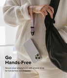 Hand Strap | Basic - A person in a cream sweater wears a pink and purple ombre wrist strap attached to a clear phone case.