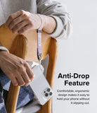 Hand Strap | Basic - A person wears a two-tone pink and purple fabric wrist strap attached to a clear smartphone case.