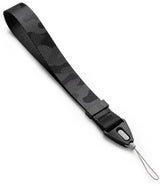 Hand Strap | Basic - Black camouflage patterned nylon wrist strap with a branded plastic connector and thin loop attachment.