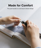Hand Strap | Basic - Hands demonstrating the one-touch push buckle release mechanism of a black fabric hand strap.