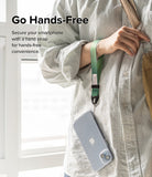Hand Strap | Basic - A person wearing a green fabric wrist strap attached to a smartphone in a clear case.