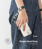Hand Strap | Lettering - A person wearing a green and white Ringke-branded fabric hand strap attached to a smartphone.