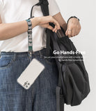 Hand Strap | Lettering - Person wearing a green and grey branded wrist strap attached to a clear smartphone case.