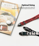 Hand Strap | Lettering - Three patterned hand straps in red, black, and green with bold white lettering and black connectors.