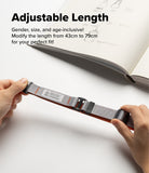 Design Lanyard Strap - Hands adjusting a grey and orange adjustable lanyard strap with black hardware over a sketchbook.