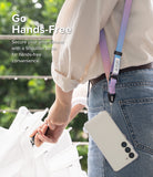 Design Lanyard Strap - Person wearing a pastel gradient shoulder strap attached to a smartphone in a clear case.