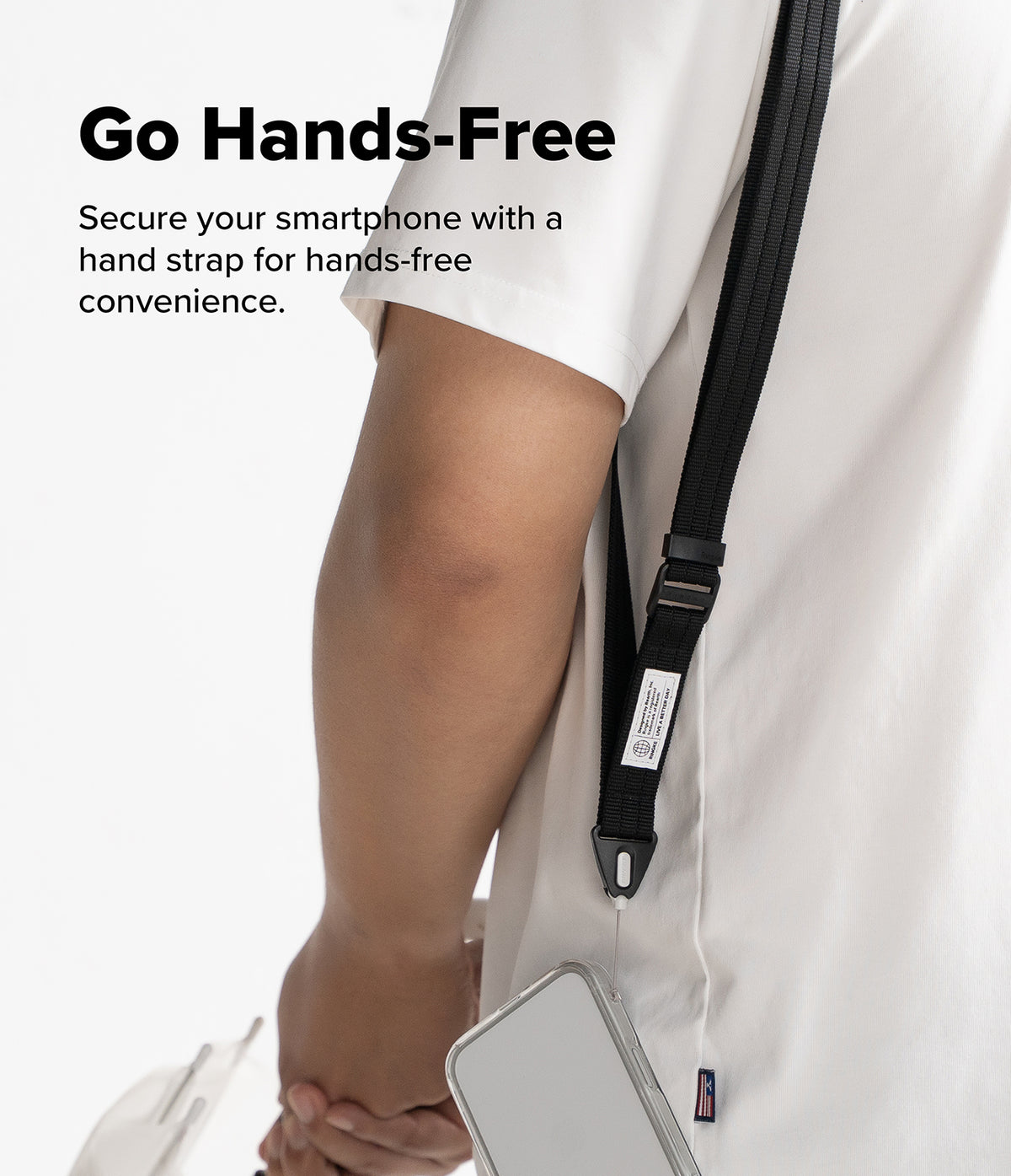 Design Lanyard Strap - A close-up of a person wearing a white shirt and holding a smartphone under a black hand strap worn across the chest, with the text 'Go Hands-Free' on a white background.