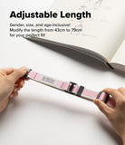 Design Lanyard Strap - Hands adjusting a pink and white striped lanyard with black buckles over an open sketchbook.