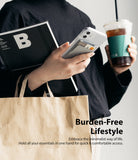 Card Holder | Slot [3 Cards] - Person holding a phone with a grey adhesive card holder containing three cards, a book, and coffee.