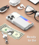 Card Holder | Side Slot - Smartphone with white card holder attached, surrounded by keys, cash, coins, earbuds, and glasses.