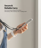 Shoulder Strap | Black / Neon Orange - A person holding a phone attached to a black shoulder strap against a neutral background.