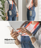 Shoulder Strap | Black / Neon Orange - Person wearing a neon orange adjustable phone shoulder strap over denim overalls.
