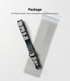 Shoulder Strap | Lettering - A grey shoulder strap with white lettering resting on its clear, branded retail packaging.
