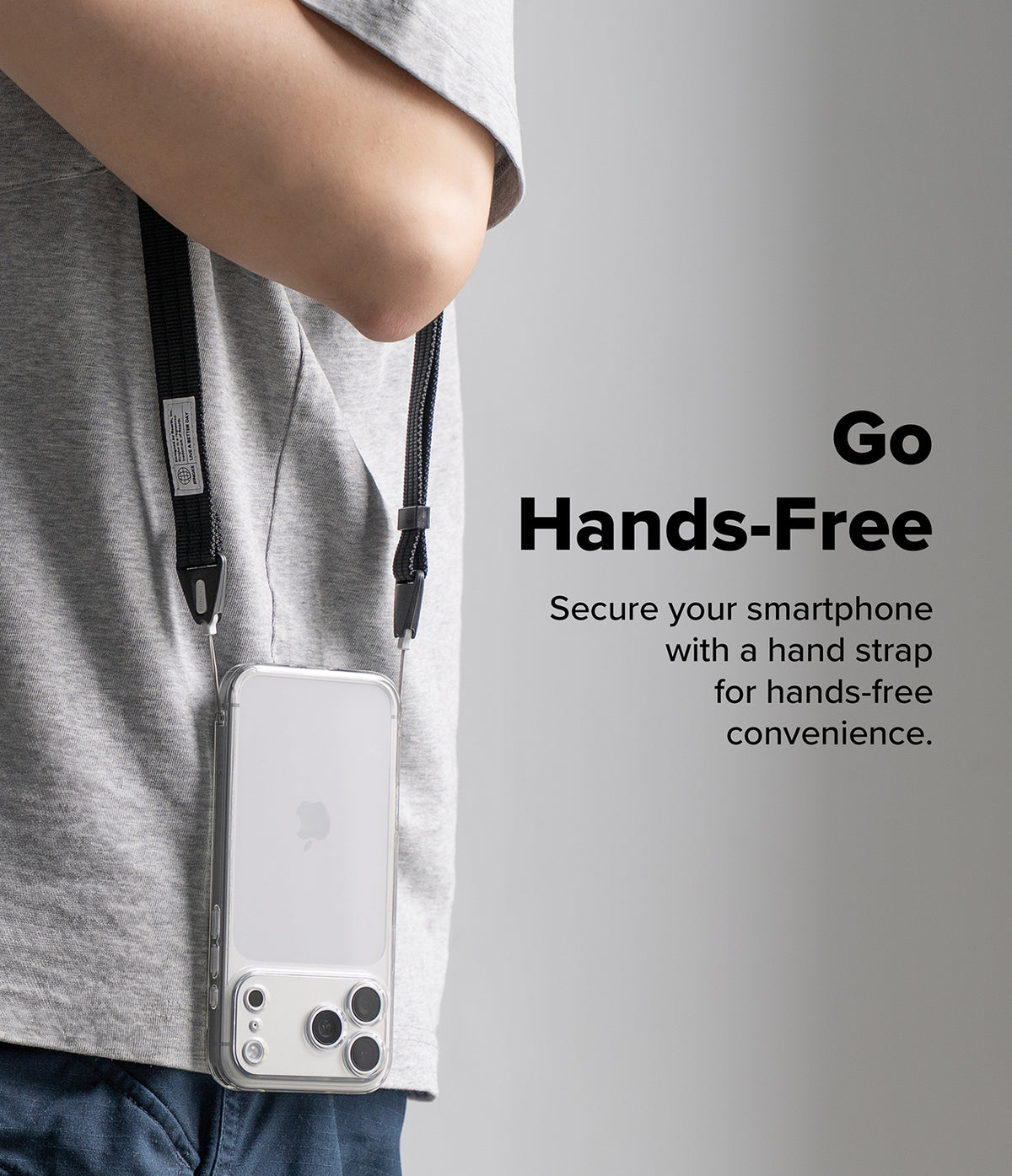 Design Shoulder Strap - A person wearing a gray t-shirt and blue jeans holds a white smartphone in a clear sleeve with a black neck strap, shown against a light gray background with the text 'Go Hands-Free'.