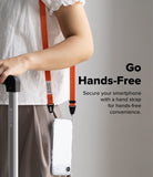 Shoulder Slim Strap - Person wearing an orange phone shoulder strap with a clear phone case, holding a suitcase handle.