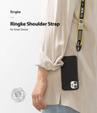 Shoulder Strap | Lettering - Person wearing a black phone case on a yellow and black branded shoulder strap with white lettering.