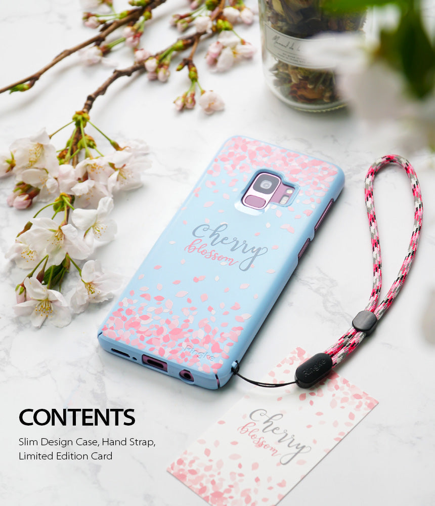 Galaxy S9 Case | Slim (Cherry Blossom) - Light blue phone case with pink petals, hand strap, and cherry blossom decor.