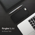 iPhone 8 / 7 Case | Slim - Matte black phone case on a dark desk with a silver pen and laptop keyboard.