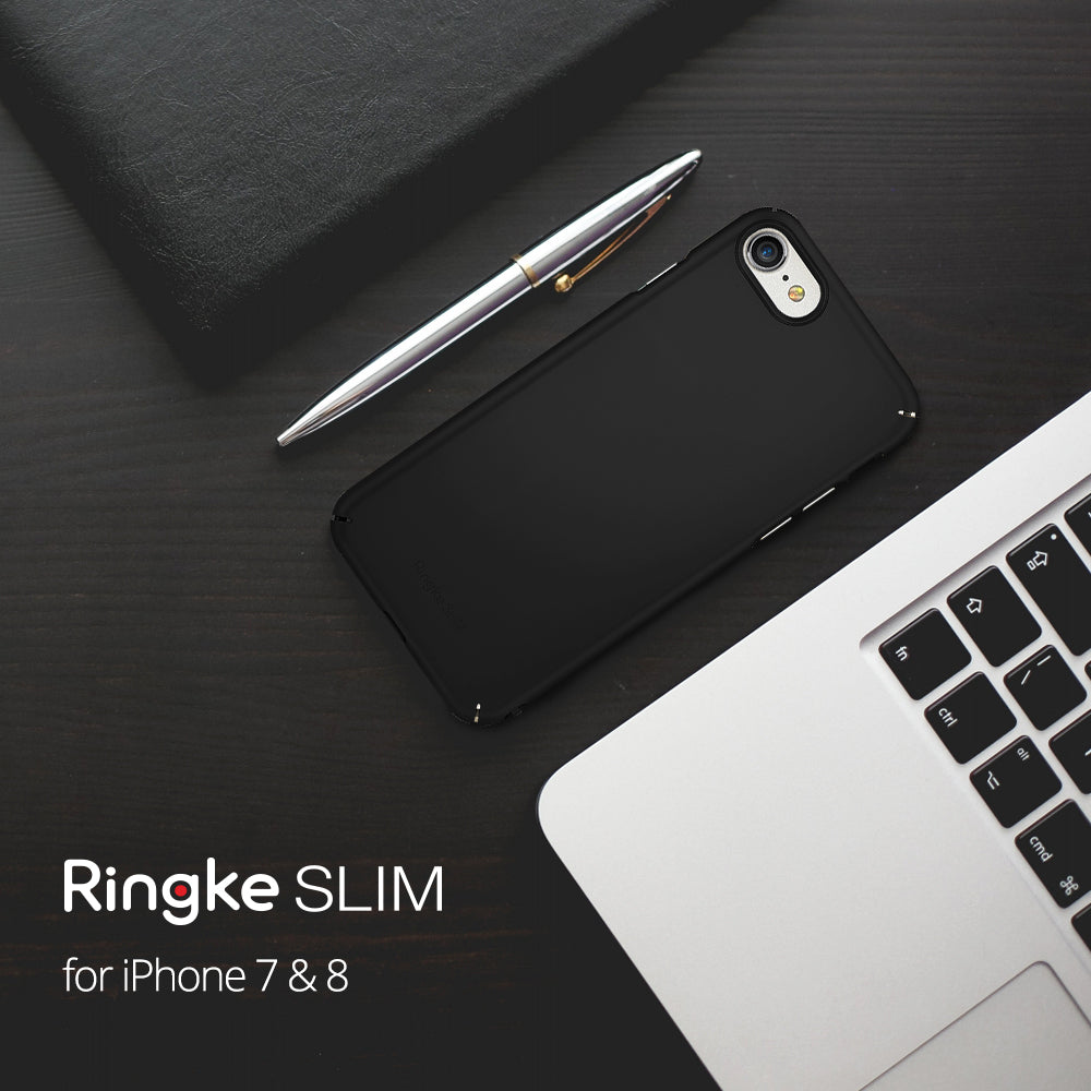 iPhone 8 / 7 Case | Slim - Matte black phone case on a dark desk with a silver pen and laptop keyboard.