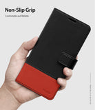 Galaxy S10 Case | Wallet - Hand holding a black and red leather wallet case for Galaxy S10 with a magnetic strap.