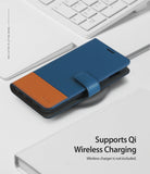 Galaxy S10e Case | Wallet - Blue and brown leather wallet case on a wireless charger next to a white keyboard.