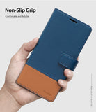 Galaxy S10e Case | Wallet - A hand holding a blue and brown leather wallet case for a Galaxy S10e with a magnetic strap.