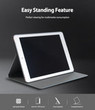 Smart Cover Design Leather Stand | iPad - An iPad in a grey leather case folded into a stand on a dark background.