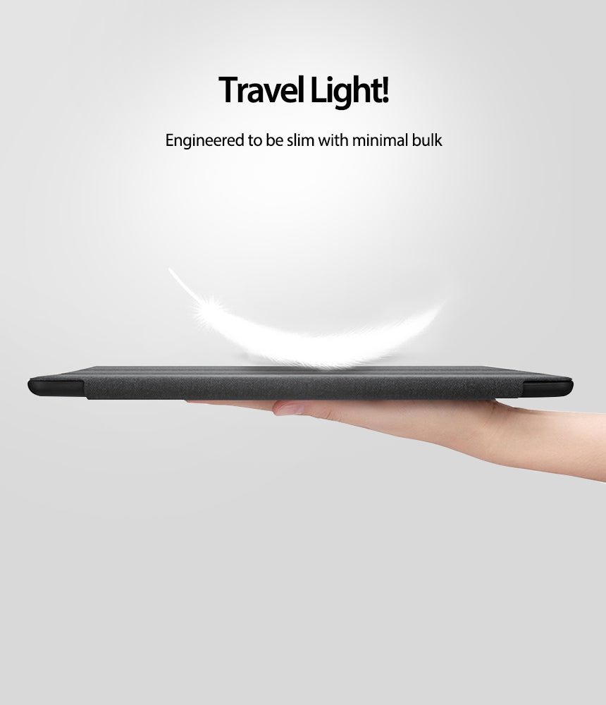 Smart Cover Clear Slim Stand | iPad - Smart Cover Clear Slim Stand - A hand holds a slim, dark gray iPad case with a white feather floating above it against a light background.