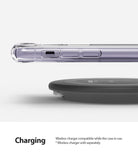 iPhone 11 Case | Fusion Design - A clear iPhone 11 case hovering above a black wireless charging pad on a white background.