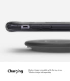 iPhone 11 Case | Fusion - Side view of a smartphone in a smoke black case hovering above a wireless charging pad.