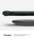 iPhone 11 Pro Max Case | Fusion-X Matte - Side view of a phone in a dark green protective case hovering over a wireless charger.