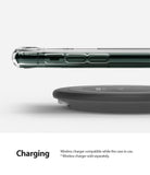 iPhone 11 Pro Case | Fusion Design - Side view of an iPhone 11 Pro in a clear case hovering above a wireless charging pad.