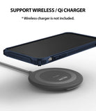 iPhone XR Case | Fusion-X - Navy iPhone XR in a rugged case hovering above a circular wireless charging pad.