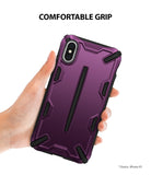 iPhone XS Case | Dual-X [DX] - Hand holding a metallic purple, rugged-style phone case with black accents against a white background.