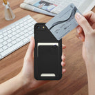 iPhone 8 / 7 / SE 2020 / SE 2022 Case | Slim/Slot - Black - Hands holding a black phone case with a card slot holding a card.
