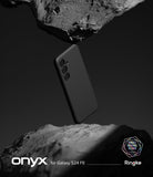 Galaxy S24 FE Case | Onyx - A black phone case floating between two jagged, dark rock formations against a black background.