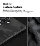 Galaxy S24 FE Case | Onyx - Close-up of a black textured phone case with a rugged, embossed camo pattern next to dark sand.