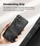 Galaxy S24 FE Case | Onyx Magnetic - Hand holding a black camo-textured phone case with a close-up of side grip details.