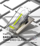 Galaxy S24 Ultra Screen Protector | Easy Slide Tempered Glass - Installation tool hovering over a smartphone screen.