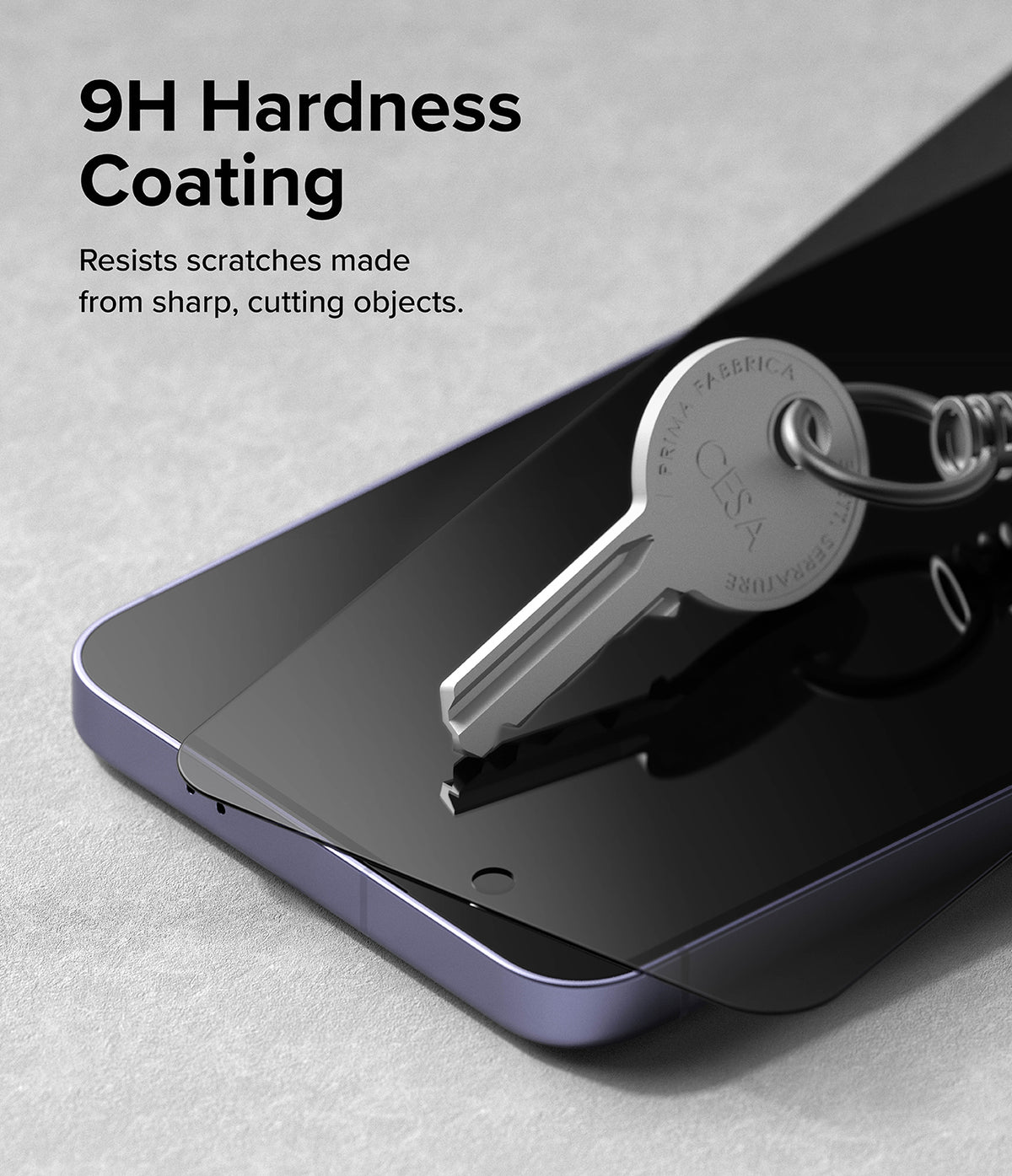Galaxy S24 Plus Screen Protector | Easy Slide Privacy Tempered Glass - Galaxy S24 Plus Screen Protector - A metal key resting on a dark privacy screen protector atop a smartphone.