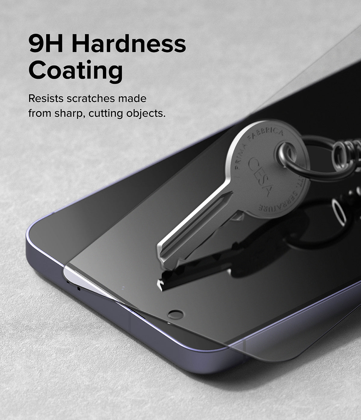 Galaxy S24 Plus Screen Protector | Easy Slide Tempered Glass - Galaxy S24 Plus Screen Protector - A metal key rests on a tempered glass screen protector atop a smartphone.
