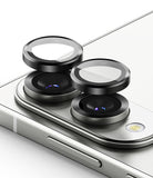Galaxy S25 Edge | Camera Lens Frame Glass - Two black circular camera lens protectors hovering above the rear lenses of a silver smartphone.
