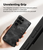 Galaxy S25 Ultra Case | Onyx - Hand holding a black camo-patterned phone case with a textured grip and camera cutouts.