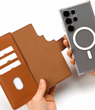 Galaxy S25 Ultra Cover | Folio Grip Wallet Magnetic - Galaxy S25 Ultra Cover - A hand detaches a clear magnetic phone case from a tan leather folio wallet with card slots.