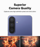 Galaxy S26 FE Camera Protector | Camera Full Cover Tempered Glass (2P) - A promotional graphic for a smartphone camera feature, showing a close-up of the back of a blue-purple phone with three rear cameras and text reading 'Superior Camera Quality.' Two small sample photos at the bottom compare image quality, labeled 'Ringke' and 'Others.