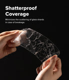Galaxy S26 FE Screen Protector | Easy Slide Tempered Glass (2P) - Hands holding a transparent, crack-resistant film over a black background, with white text reading 'Shatterproof Coverage' and a smaller explanatory subtitle about minimizing glass shard scattering.